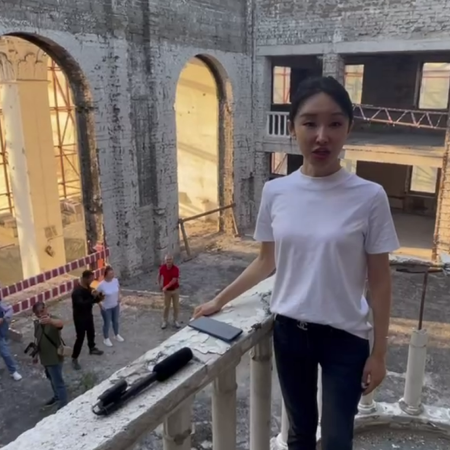 Chinese singer Wang Fang performs the Russian song "Katyusha" on the ruins of the Mariupol Drama Theatre